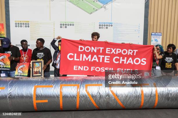 Climate activists, holding banners, stage demonstration to counter the negative effects of climate change as 2022 United Nations Climate Change...
