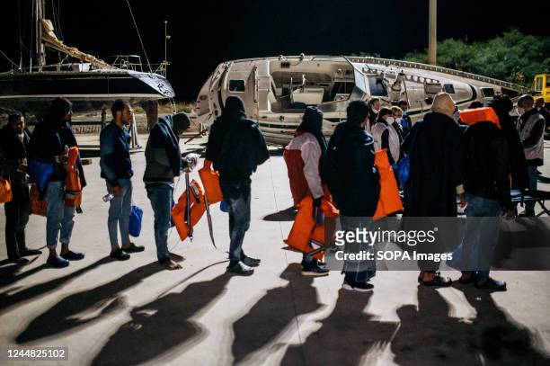 Migrants were seen walking to the first aid camp upon their arrival in roccella's port. 28 migrants, mainly from Bangladesh, have been rescued on a...