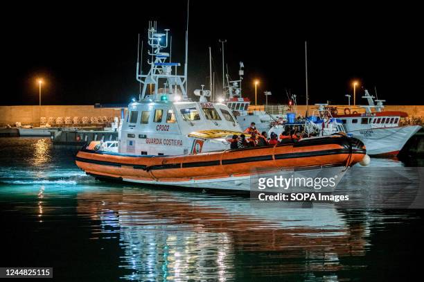 Patrol boat of the Italian Coast Guard is seen entering Roccella's Port . 28 migrants, mainly from Bangladesh, have been rescued on a boat in...