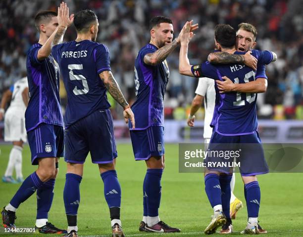 Argentina's forward Lionel Messi celebrates with teammates after scoring during the friendly football match between Argentina and the United Arab...