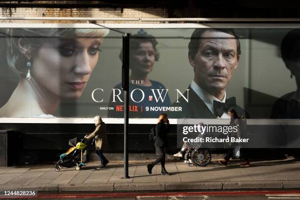 An advertising billboard promoting series 5 of Netflix's 'The Crown' which is now airing on demand, shows the main characters of the British royal...