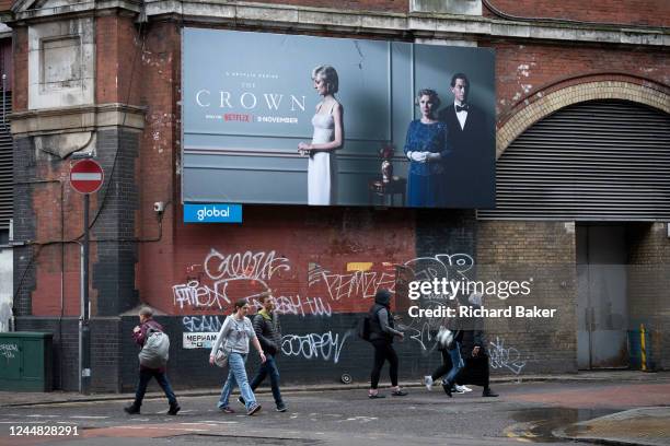 An advertising billboard promoting series 5 of Netflix's 'The Crown' which is now airing on demand, shows the main characters of the British royal...