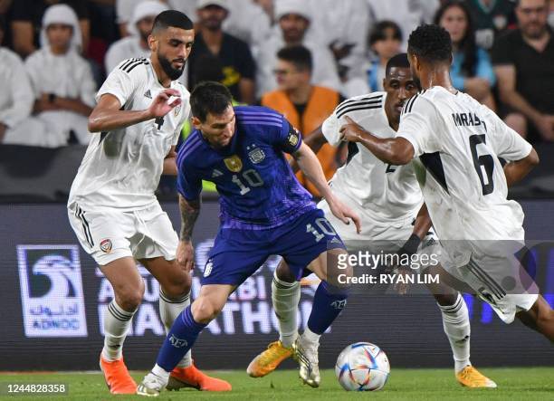 Argentina's forward Lionel Messi is marked by UAE players during the friendly football match between Argentina and the United Arab Emirates at the...