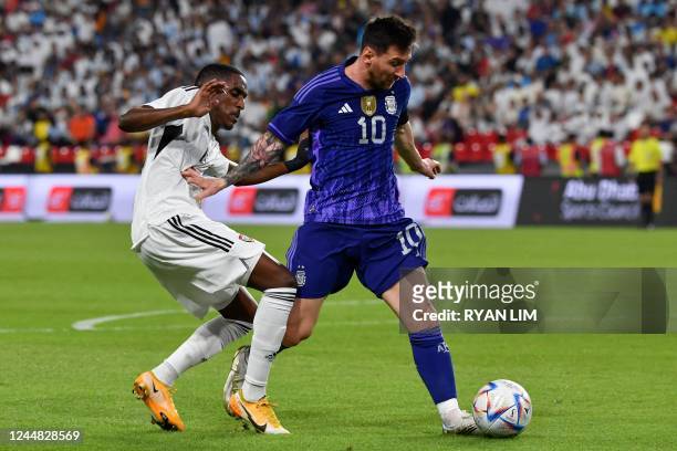 United Arab Emirates' defender Khalifa Al Hammadi marks Argentina's forward Lionel Messi during the friendly football match between Argentina and the...