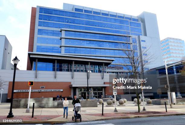 Couple crosses the street in front of the Leonard L. Williams Justice Center on November 16, 2022 in Wilmington, Delaware. Elon Musk is on trial at...