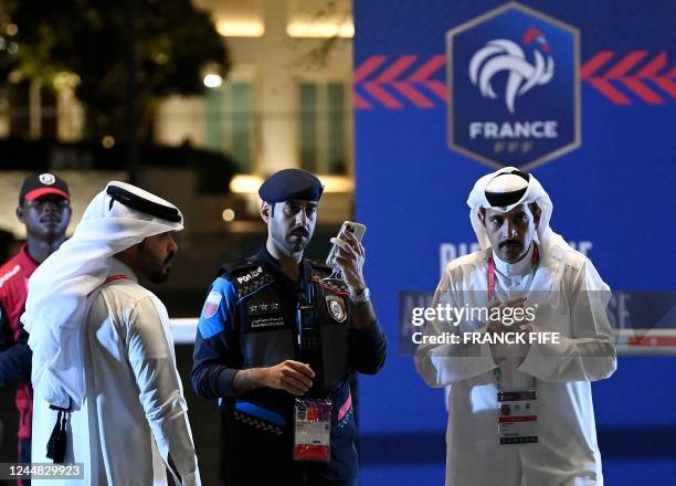 Security guard stands at the entrance of the hotel of France's national football team prior to the arrival of the players in Doha on November 16...