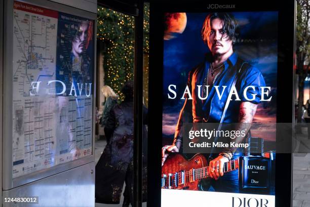 Advertising for the Dior mens fragrance Sauvage featuring American actor and film star Johnny Depp on a bus stop on Oxford Street as it is announced...