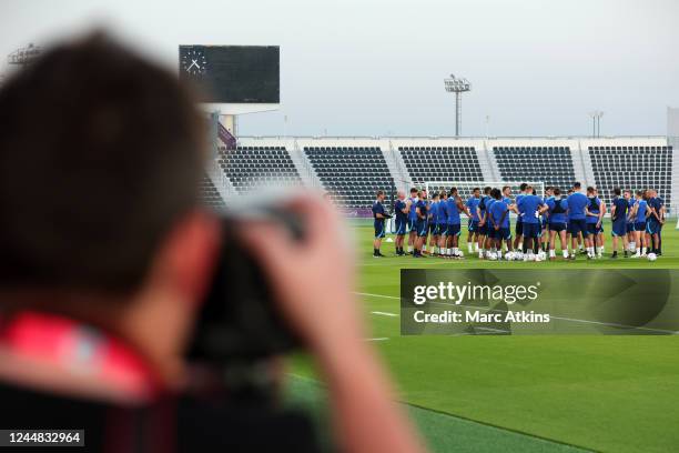 England players huddle as media look on during the England Training Session at Al Wakrah Stadium on November 16, 2022 in Doha, Qatar.