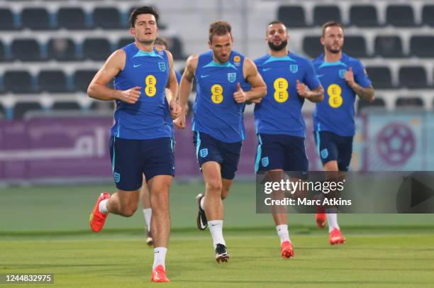Harry Maguire; Harry Kane, Kyle Walker and James Maddison of England during the England Training Session at Al Wakrah Stadium on November 16, 2022 in...