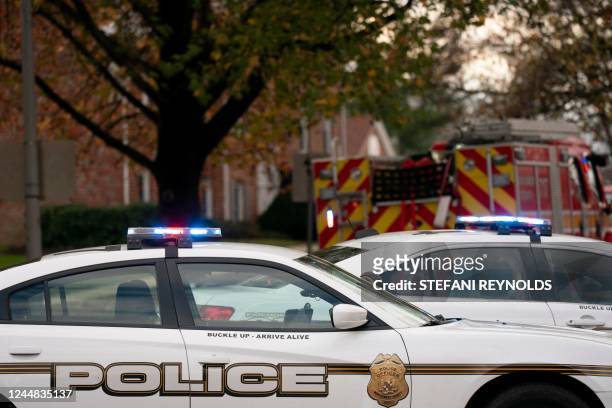 Police vehicles block the street near the site of a fire caused by an explosion at an apartment building in which 12 people were reported injured,...