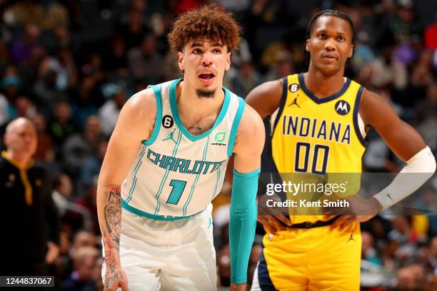 LaMelo Ball of the Charlotte Hornets and Bennedict Mathurin of the Indiana Pacers looks on during the game on November 16, 2022 at Spectrum Center in...
