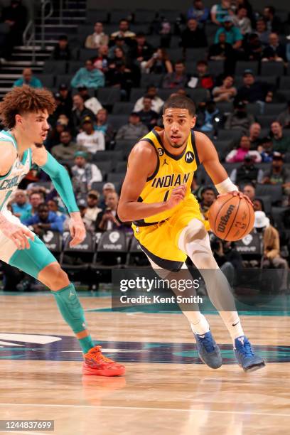 Tyrese Haliburton of the Indiana Pacers dribbles the ball against the Charlotte Hornets on November 16, 2022 at Spectrum Center in Charlotte, North...