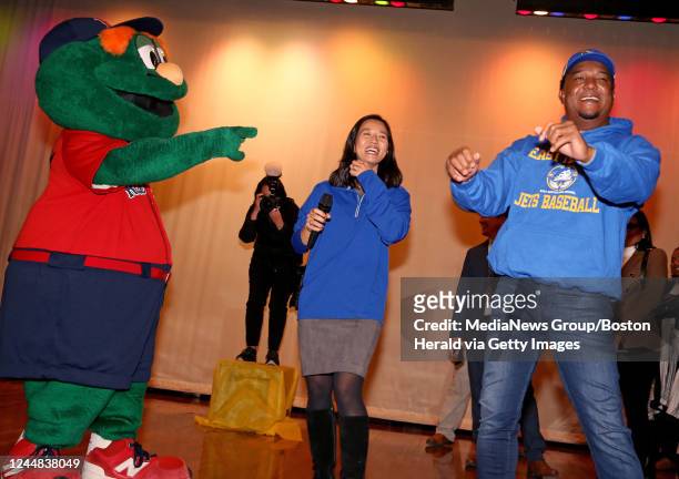 November 10: Wally the Green Monster points as Mayor Michelle Wu laughs at former Red Sox great, Pedro Martinez as he dances at East Boston High...