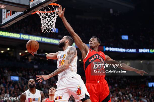 Christian Koloko of the Toronto Raptors tries to block a shot by Caleb Martin of the Miami Heat during the first half of their NBA game at Scotiabank...