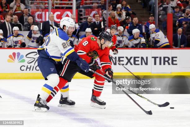 Chicago Blackhawks defenseman Jack Johnson fights for the puck against St. Louis Blues left wing Brandon Saad during an NHL game on November 16, 2022...