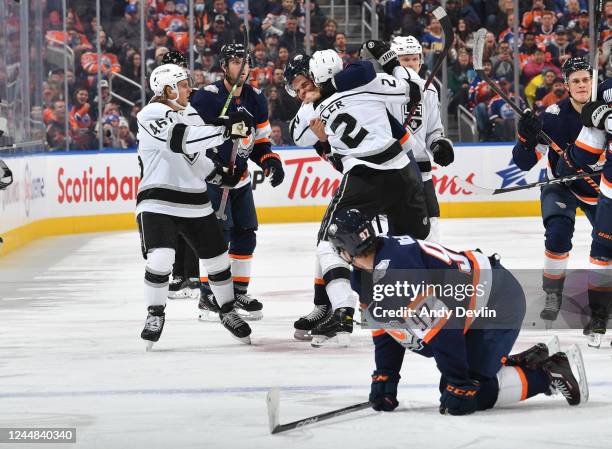 Connor McDavid of the Edmonton Oilers looks on while Darnell Nurse scrums with Alexander Edler of the Los Angeles Kings during the game on November...