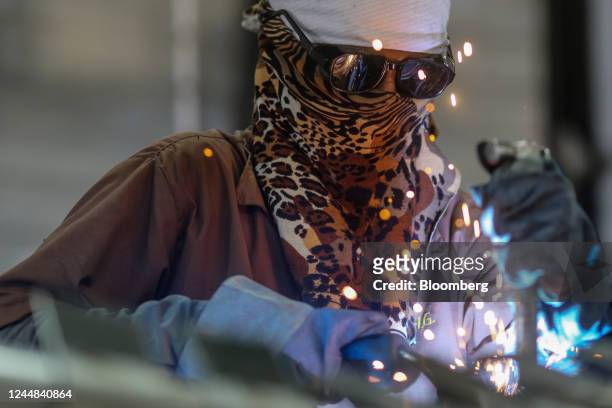 Worker solders the joints of cookstove parts at the fuel efficient cookstove manufacturing plant of GHG Reduction Technologies Pvt., a subsidiary of...