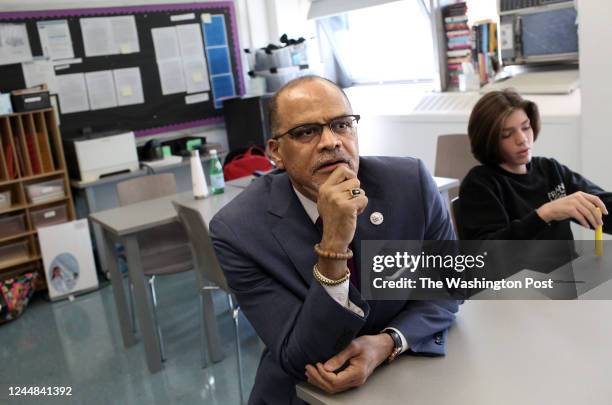 David C. Banks, the chancellor of the New York City public schools, sits down with students at a desk while taking a tour of classrooms in the Urban...