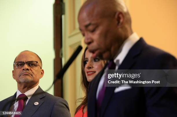 David C. Banks, the chancellor of the New York City public schools, and Assemblywoman Jenifer Rajkumar, listen to New York mayor Eric Adams at the...