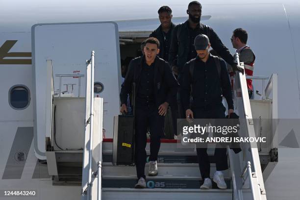 Members of the German team including Germany's midfielder Jamal Musiala disembark the airplane after arriving at the airport in Doha, Qatar on...
