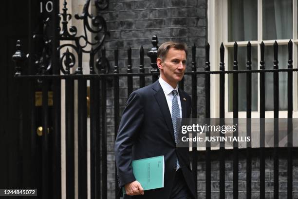 Britain's Chancellor of the Exchequer Jeremy Hunt leaves Downing Street in central London on his way to make a full budget statement in the House of...