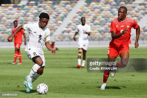 Ghana's defender Tariq Lamptey vies for the ball with Switzerland's defender Denis Zakaria during a friendly football match between Ghana and...