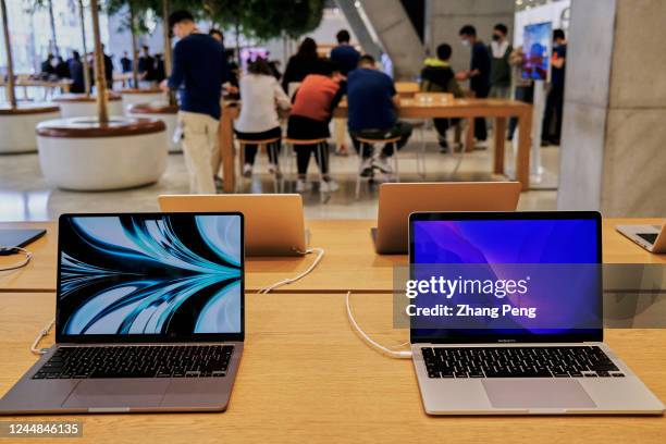 Apple's Macbook products on a table in an Apple store. According to the fourth quarters financial report of Apple in 2022, sales of Mac products are...