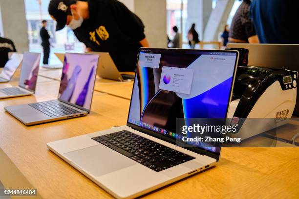 Apple's Macbook products on a table in an Apple store. According to the fourth quarters financial report of Apple in 2022, sales of Mac products are...