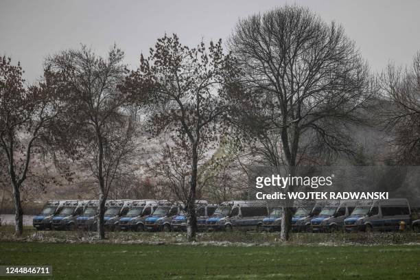 Police cars are seen lined up in the eastern Poland village of Przewodow where missile strike killed two men, near the border with war-ravaged...