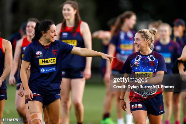 Sinead Goldrick and Tyla Hanks of the Demons share a laugh during the Melbourne Demons AFLW training session at Gosch's Paddock on November 17, 2022...