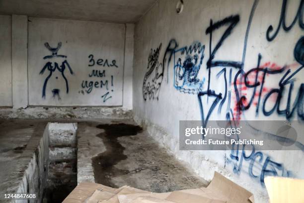 Graffiti covers the wall in the pre-trial detention centre where Russian invaders set up a torture chamber, Kherson, southern Ukraine.