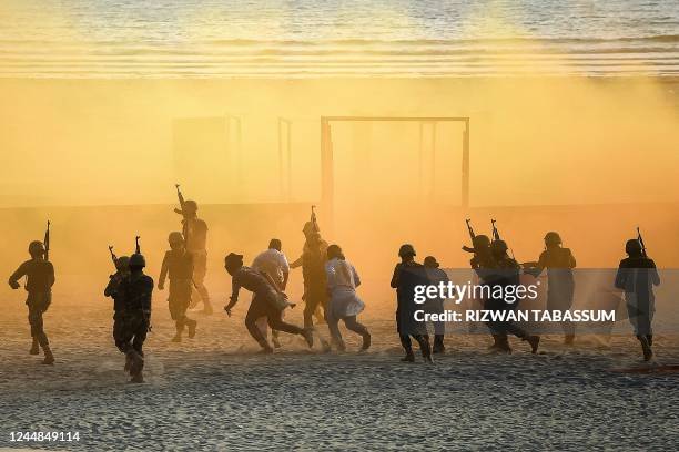 Pakistani naval marine take part in a drill during the International Defence Exhibition and Seminar 2022 at the beach in Karachi on November 17, 2022.