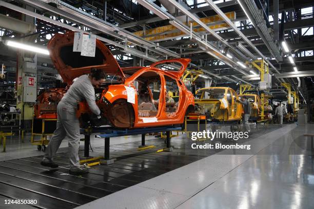 Employees fit parts to the body shells of Renault Twingo and Clio automobiles on the production line at the Renault Revoz d.d. Plant, a unit of...