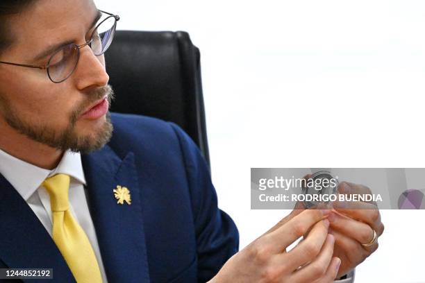 General Manager of the Central Bank of Ecuador Guillermo Avellan shows the new commemorative coin for Ecuadors fourth World Cup participation at the...