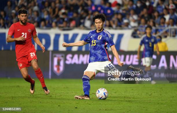 Kamada Daichi of of Japan passes the ball during the international friendly between Japan and Canada at Al-Maktoum Stadium on November 17, 2022 in...