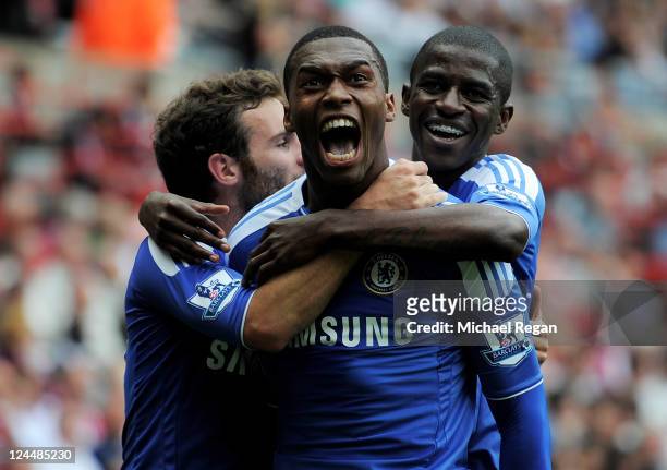 Daniel Sturridge of Chelsea celebrates with team mates Ramires and Juan Mata after scoring his team's second goal during the Barclays Premier League...