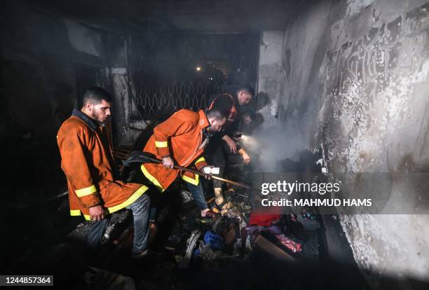 Palestinian firefighters extinguish a fire which broke out in one of the apartments in the Jabalia refugee camp in the northern Gaza strip, on...