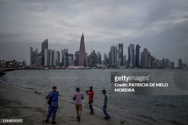 People take pictures with Doha skyline on November 17 ahead of the Qatar 2022 World Cup football tournament.