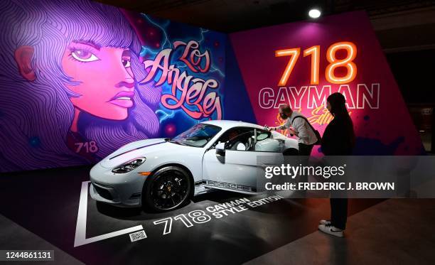 People view the Porsche 718 Cayman Style Edition on display at the 2022 Los Angeles Auto Show in Los Angeles, California on November 17, 2022.