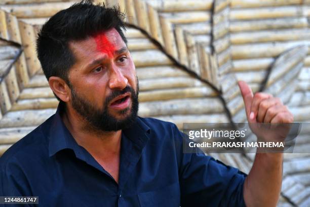 In this picture taken on November 12 former television host and Independent Party's candidate in Nepal's general election Rabi Lamichhane gestures as...