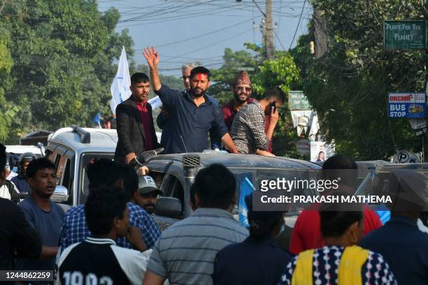 In this picture taken on November 12 former television host and Independent Party's candidate in Nepal's general election Rabi Lamichhane waves from...