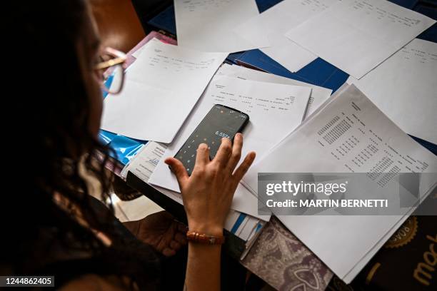 Josseline Duarte checks bills at her house in Buin, Chile, on November 15, 2022. - Chile implemented on November 18 the National Register of Child...