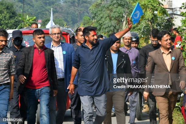 In this picture taken on November 12 former television host and Independent Party's candidate in Nepal's general election Rabi Lamichhane waves...