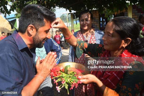 In this picture taken on November 12 former television host and Independent Party's candidate in Nepal's general election Rabi Lamichhane meets...