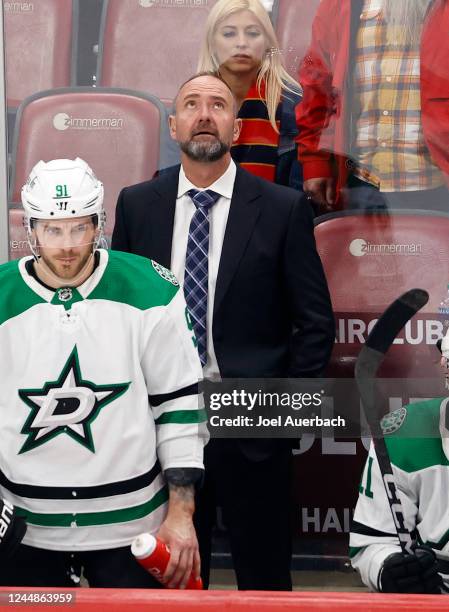 Head coach Peter DeBoer of the Dallas Stars watches a replay during a break in the third period against the Florida Panthers at the FLA Live Arena on...
