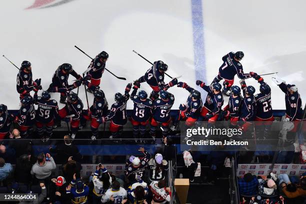 Sean Kuraly of the Columbus Blue Jackets celebrates his empty-net goal with his teammates during the third period of a game against the Montreal...