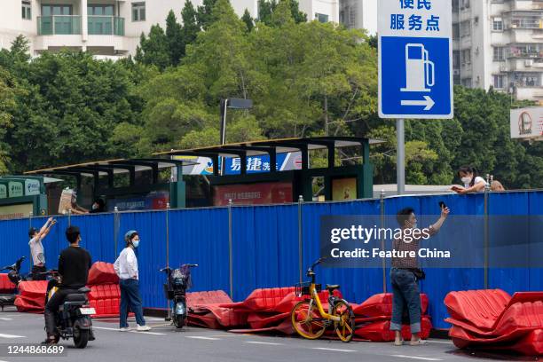 People communicate over the fence encircling a Covid-19 lockdown zone in Guangzhou in south China's Guangdong province Thursday, Nov. 17, 2022.