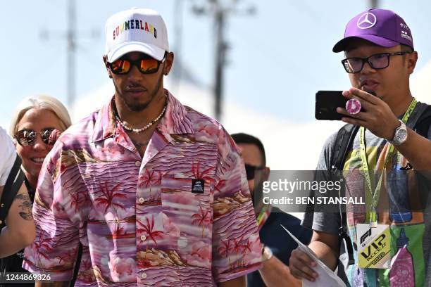 Mercedes' British driver Lewis Hamilton arrives before the first practice session ahead of the Abu Dhabi Formula One Grand Prix at the Yas Marina...