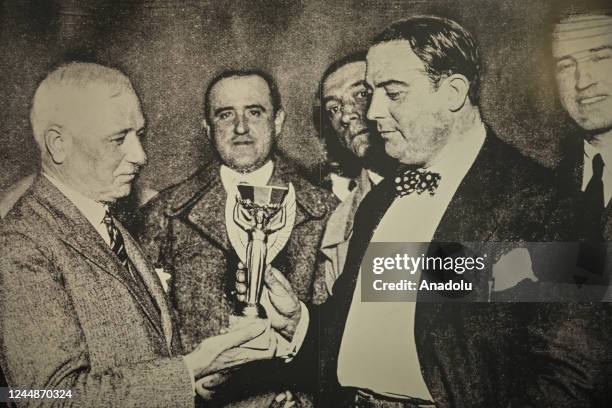 Jules Rimet hands over the trophy to Raul Jude, president of the Uruguayan Soccer Association at the time, upon winning the 1930 championship...