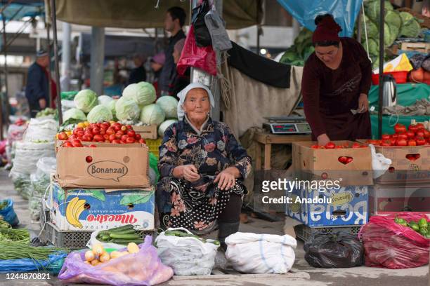 Women sell organic vegetables, which are grown in their own gardens, at Rishton bazaar as daily life continues in Rishton, Uzbekistan on October 28,...